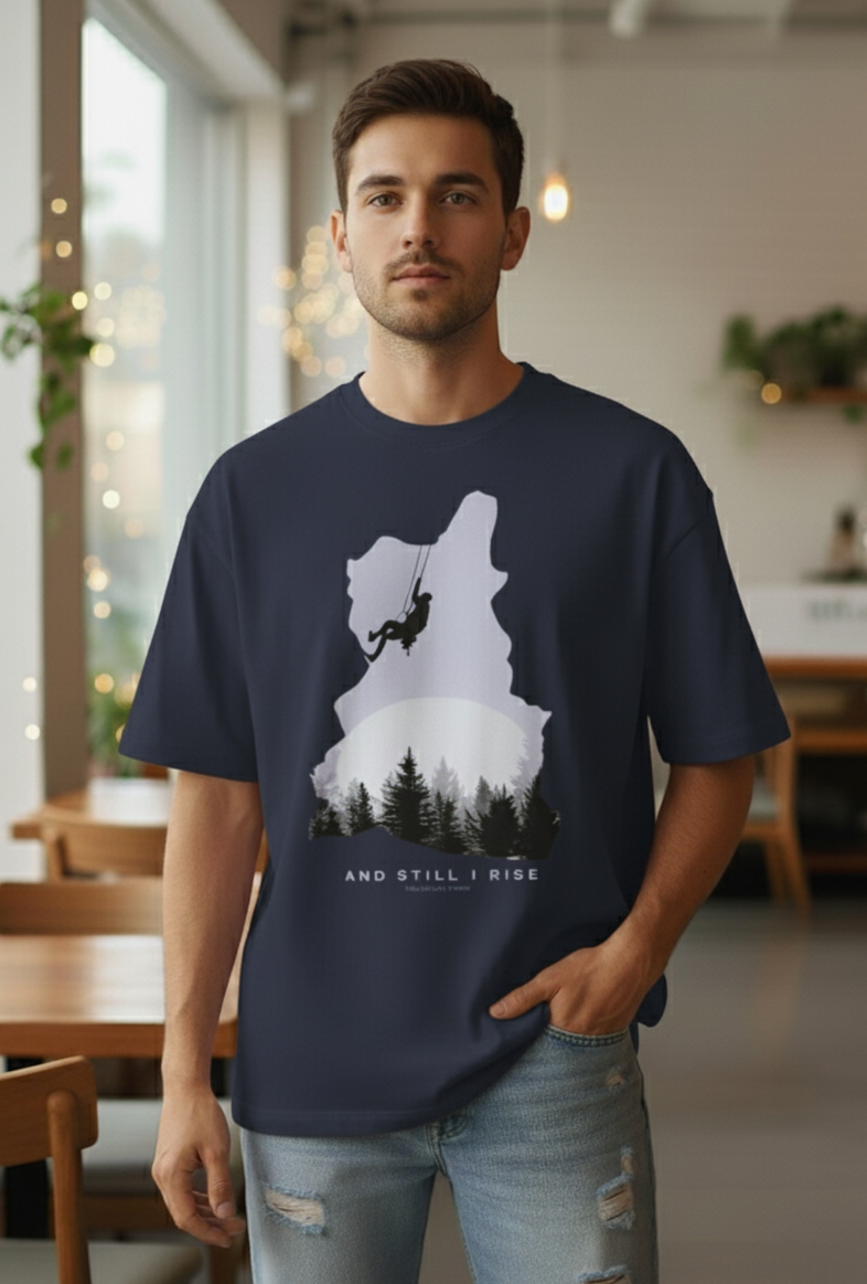 Man wearing Navy Blue oversized t-shirt with mountain climber silhouette and forest graphic – And Still I Rise print by The Smoky Skull Front
