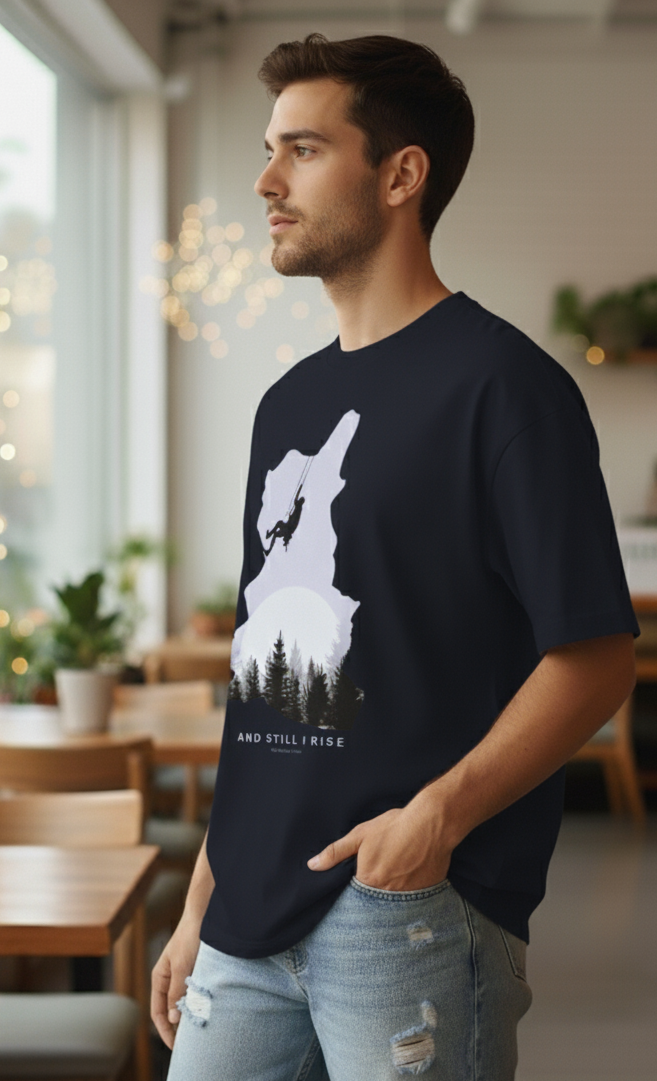 man wearing Navy Blue oversized t-shirt with mountain climber silhouette and forest graphic – And Still I Rise print by The Smoky Skull Side