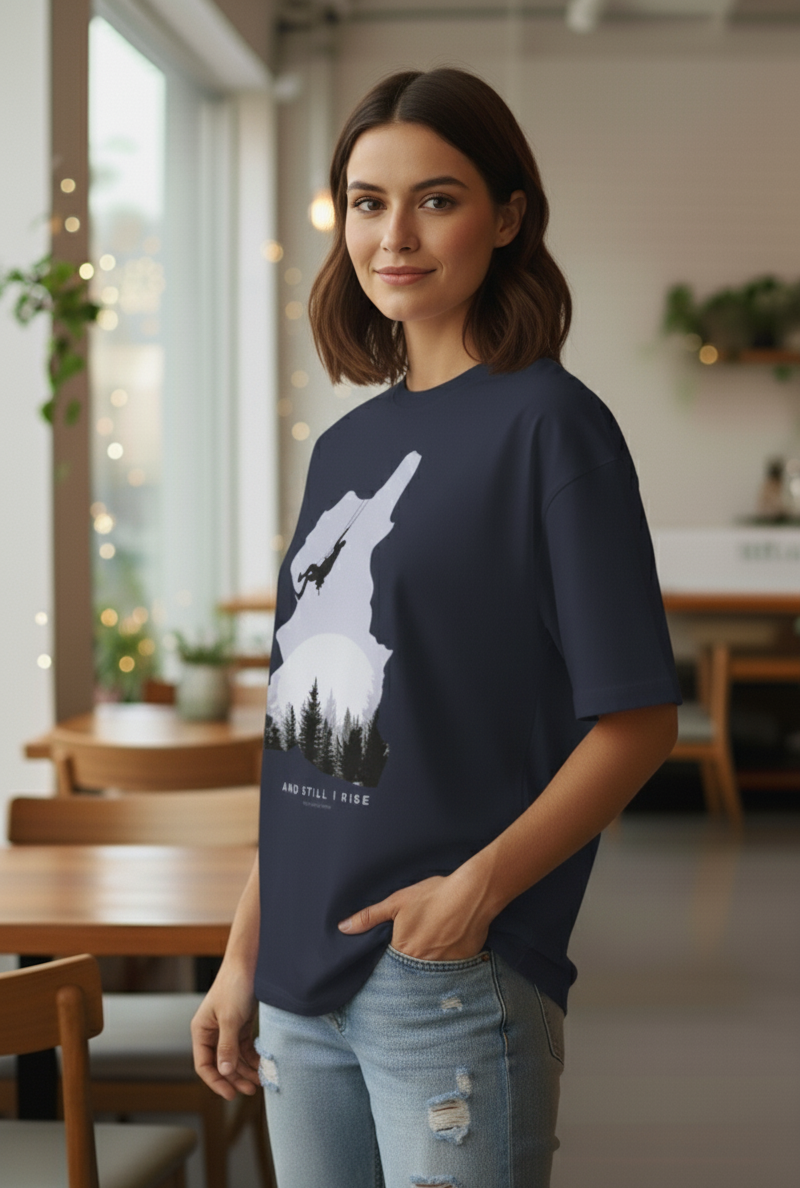 Woman wearing Navy Blue oversized t-shirt with mountain climber silhouette and forest graphic – And Still I Rise print by The Smoky Skull Side